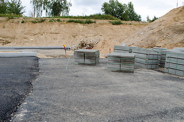 Image showing new asphalt road construction site. tiles curbs 