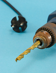 Image showing rusty old electric drill golden bit closeup 