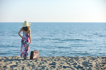 Image showing woman with suitcase on the beach