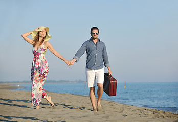 Image showing couple on beach with travel bag