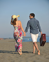 Image showing couple on beach with travel bag