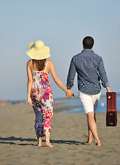 Image showing couple on beach with travel bag