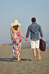 Image showing couple on beach with travel bag