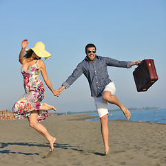 Image showing couple on beach with travel bag
