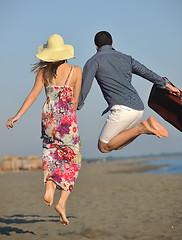 Image showing couple on beach with travel bag