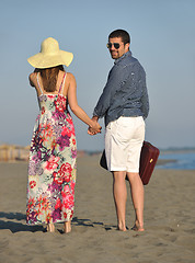 Image showing couple on beach with travel bag