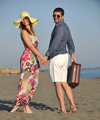 Image showing couple on beach with travel bag