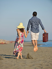 Image showing couple on beach with travel bag