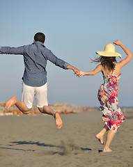 Image showing couple on beach with travel bag