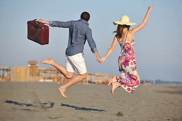 Image showing couple on beach with travel bag