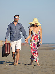 Image showing couple on beach with travel bag