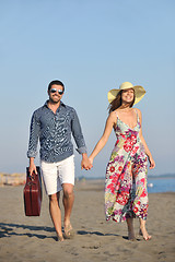 Image showing couple on beach with travel bag