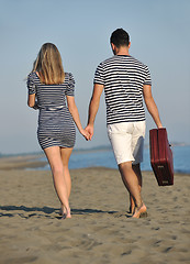 Image showing couple on beach with travel bag