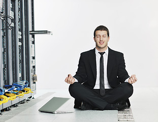 Image showing businessman with laptop in network server room