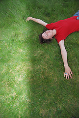 Image showing woman laying in grass