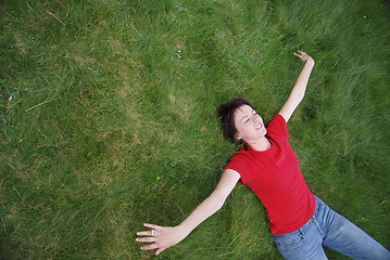 Image showing woman laying in grass