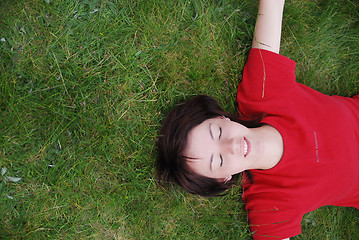 Image showing woman laying in grass