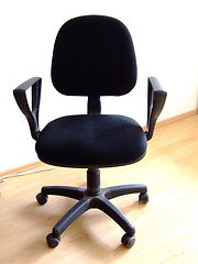 Image showing black office chair on parquet