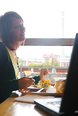 Image showing woman eating at an restaurant