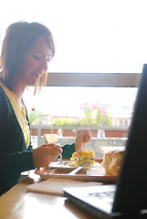 Image showing woman eating at an restaurant