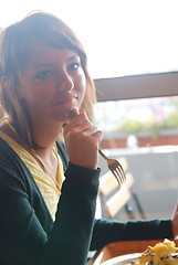 Image showing woman eating at an restaurant