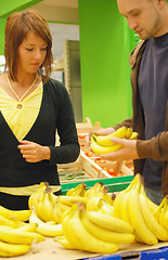 Image showing happy couple buying bananas