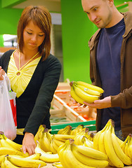 Image showing happy couple buying bananas