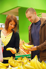 Image showing happy couple buying bananas