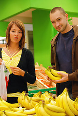 Image showing happy couple buying bananas