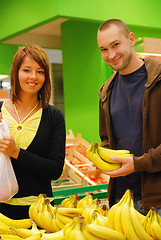 Image showing happy couple buying bananas