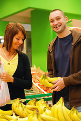 Image showing happy couple buying bananas