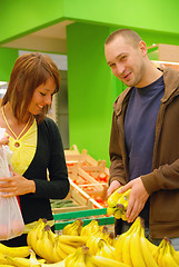 Image showing happy couple buying bananas