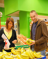 Image showing happy couple buying bananas