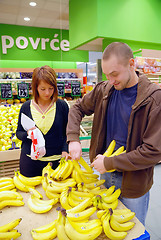 Image showing happy couple buying bananas