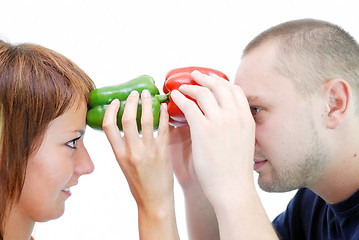 Image showing happy couple holding peppers with head