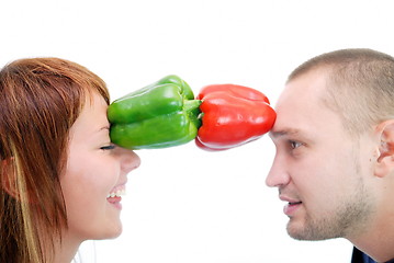 Image showing happy couple holding peppers with head