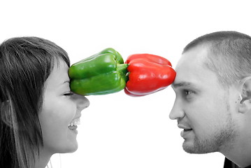 Image showing happy couple holding peppers with head