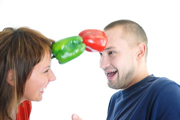 Image showing happy couple holding peppers with head