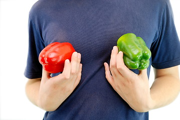 Image showing happy couple holding peppers with head