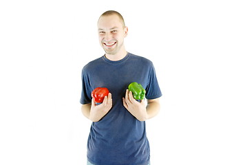 Image showing happy couple holding peppers with head