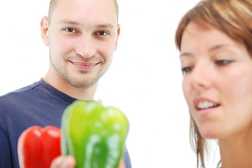 Image showing happy couple with peppers isolated