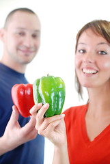 Image showing happy couple with peppers isolated