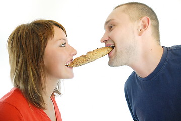 Image showing happy couple eating croissant