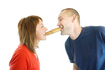 Image showing happy couple eating croissant