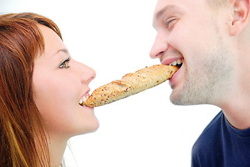 Image showing happy couple eating croissant