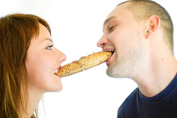 Image showing happy couple eating croissant