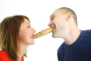 Image showing happy couple eating croissant