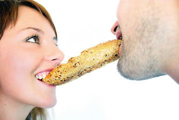 Image showing happy couple eating croissant