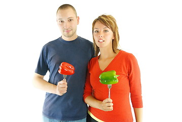 Image showing happy couple with peppers isolated