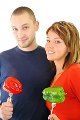 Image showing happy couple with peppers isolated